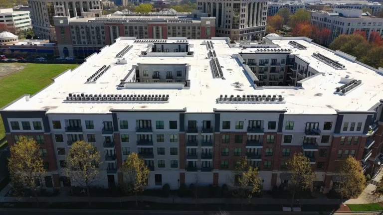Aerial view of a mid-rise apartment roofline and facade