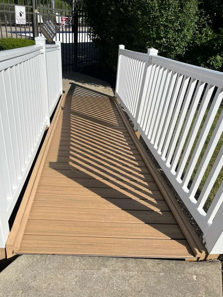 Composite access ramp with white railings built by AVB Construction