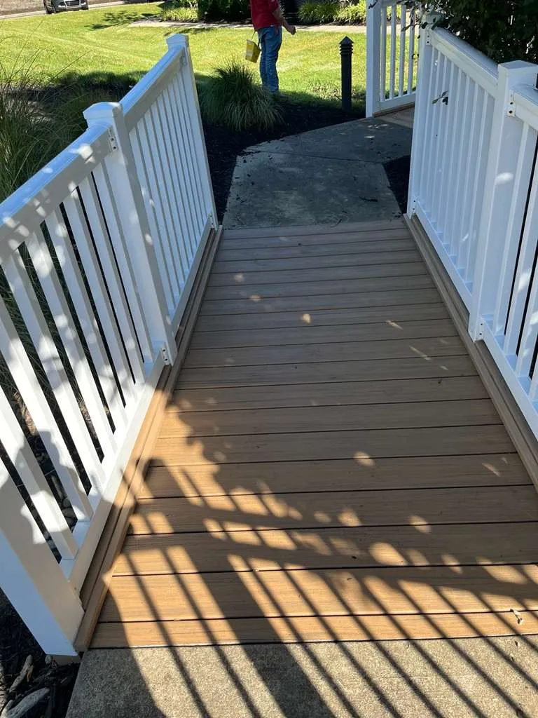 Renovated deck walkway and ramp with new vinyl railing by AVB Construction